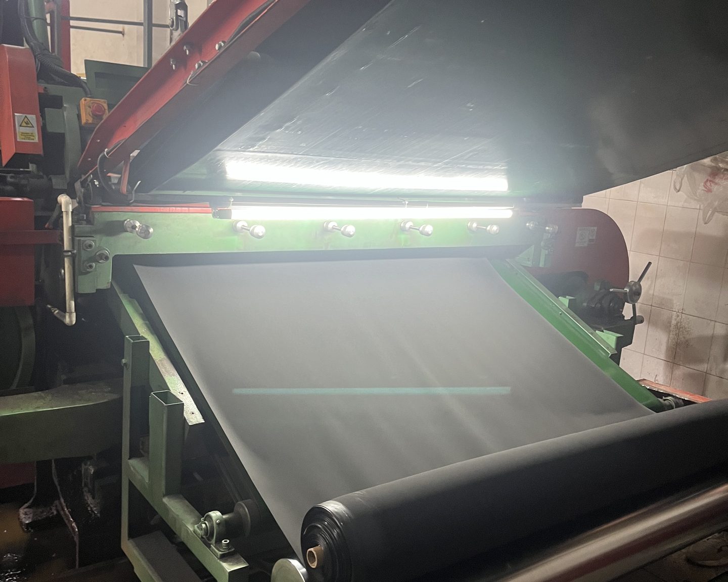 Freshly split neoprene sheet leaving the splitting machine and winding onto a roller